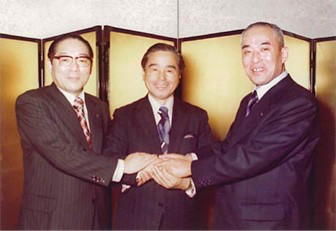 ASICS founders holding hands